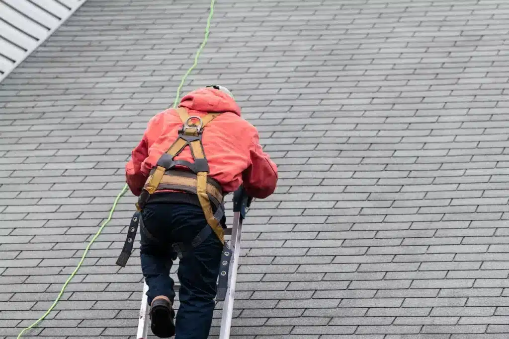roofing contractor on the roof of a residential home