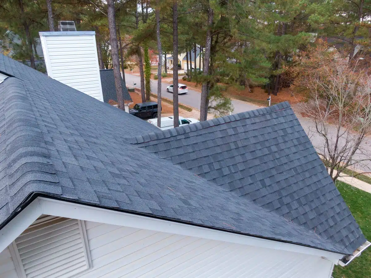 house roof with gray asphalt shingles: roof insurance claim